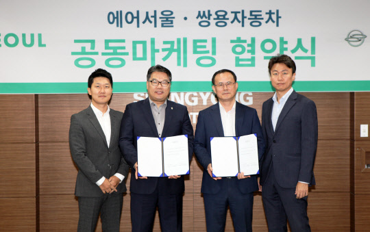 쌍용자동차는 에어서울과 차량 구매자를 대상으로 왕복항공권을 무료로 제공하는 협력 마케팅을 한다고 5일 밝혔다. 사진은 김광호 쌍용차 국내영업본부 상무(가운데 오른쪽)와 조진만 경영본부장(가운데 왼쪽) 등 행사 참가자들이 기념촬영을 하고 있는 모습. <쌍용자동차 제공>